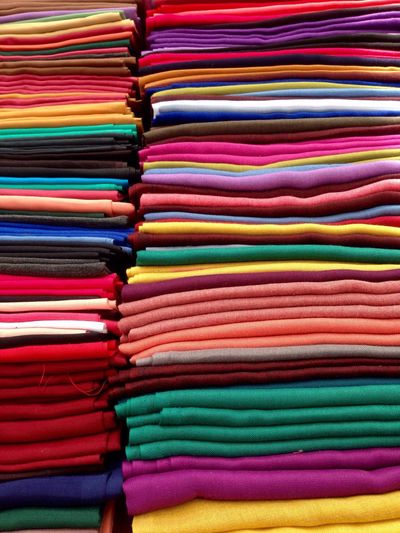 Full frame shot of stacked textiles for sale at market stall