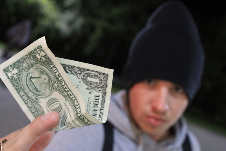Portrait of man with one dollar bill