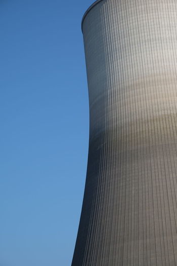 Low angle view of smoke stack against clear sky