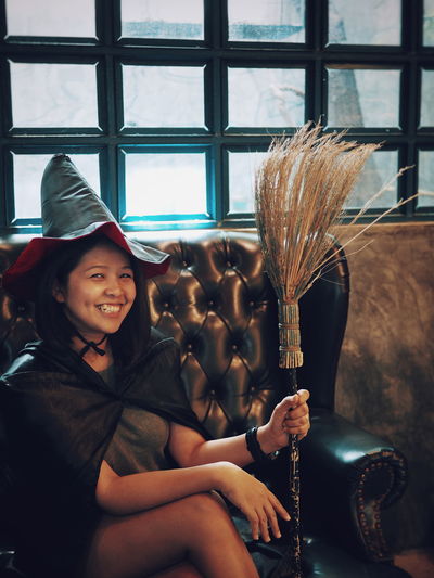 Portrait of young woman in witch costume during halloween