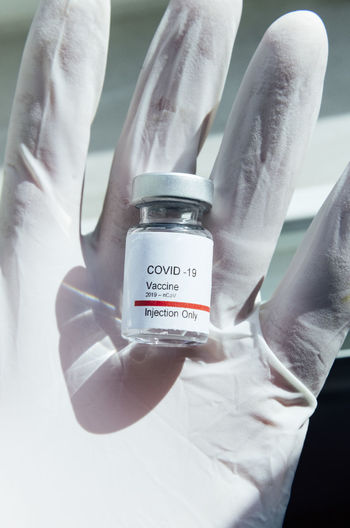 Doctor's hand showing covid-19 vaccine, new york
