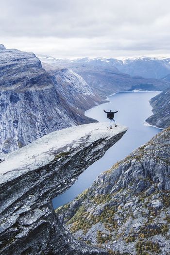 High angle view of man standing on mountain against sky