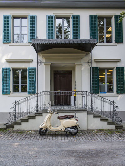 Scooter parked in front of building in zurich