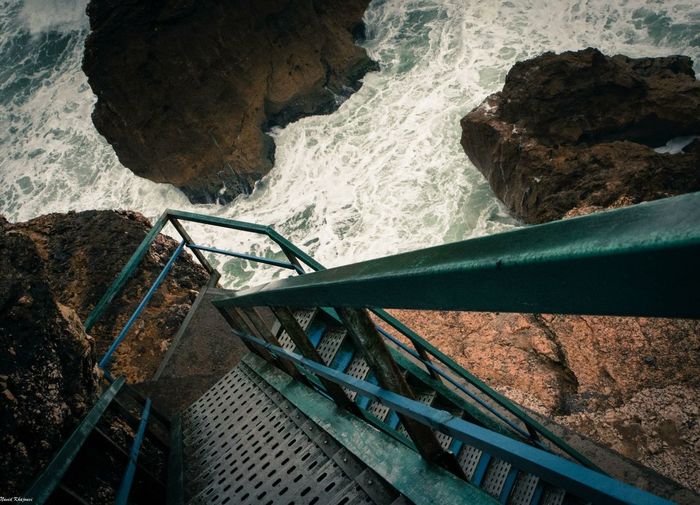 Metallic stairs leading towards sea