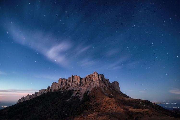 Low angle view of mountain against sky at night