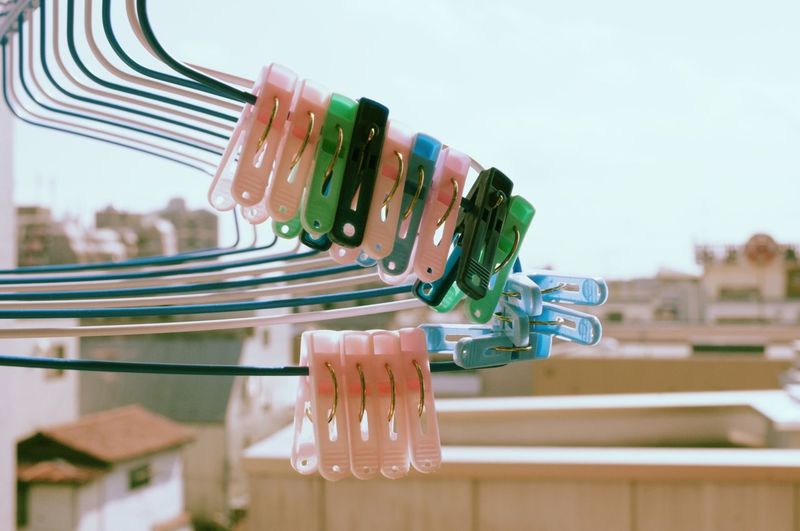 Close-up of pegs on cropped hangers