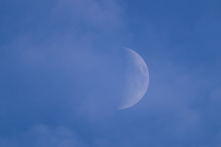 Low angle view of half moon in sky