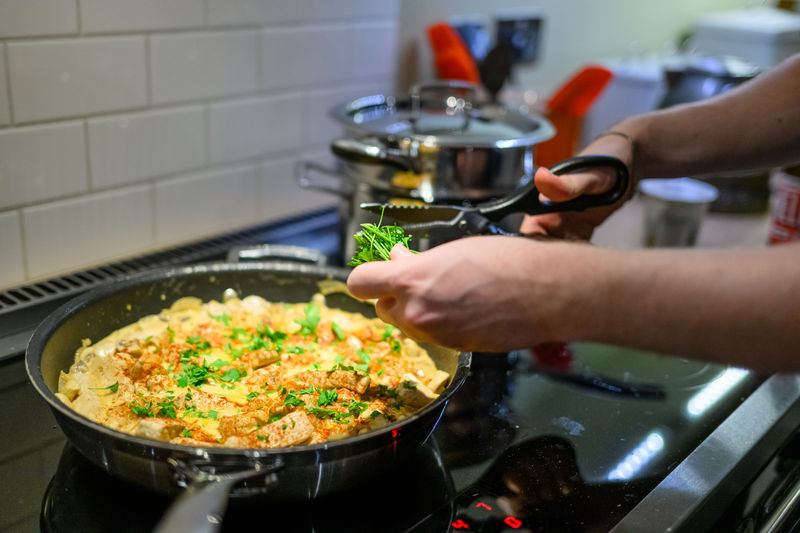 Cropped hand of man preparing food