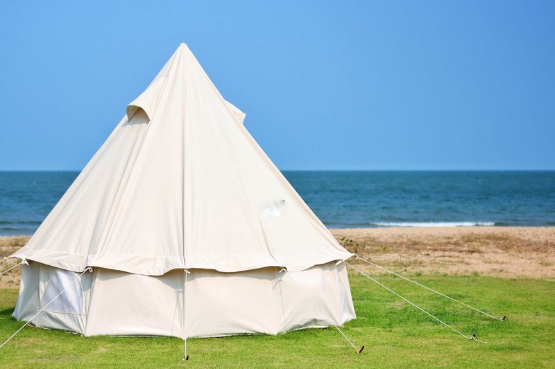 Tent on beach against clear sky