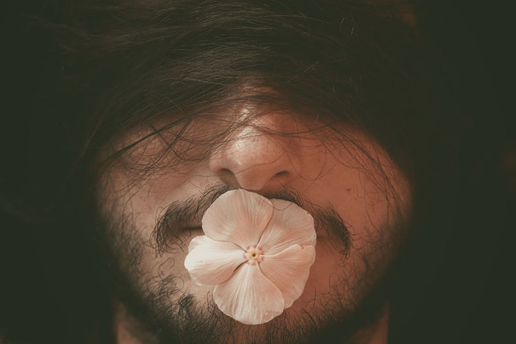 Close-up of man face with hairs and flower