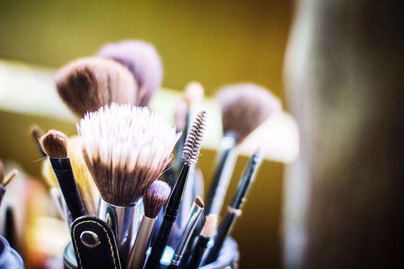 Close-up of make-up brushes against blurred background