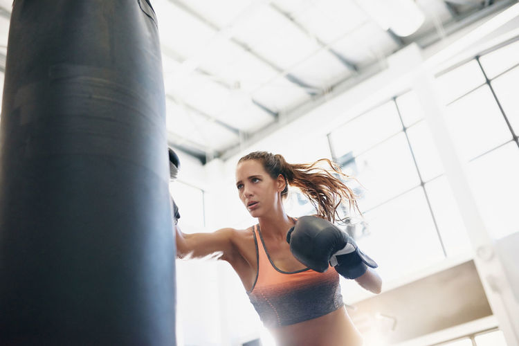 Low angle view of female boxer at gym