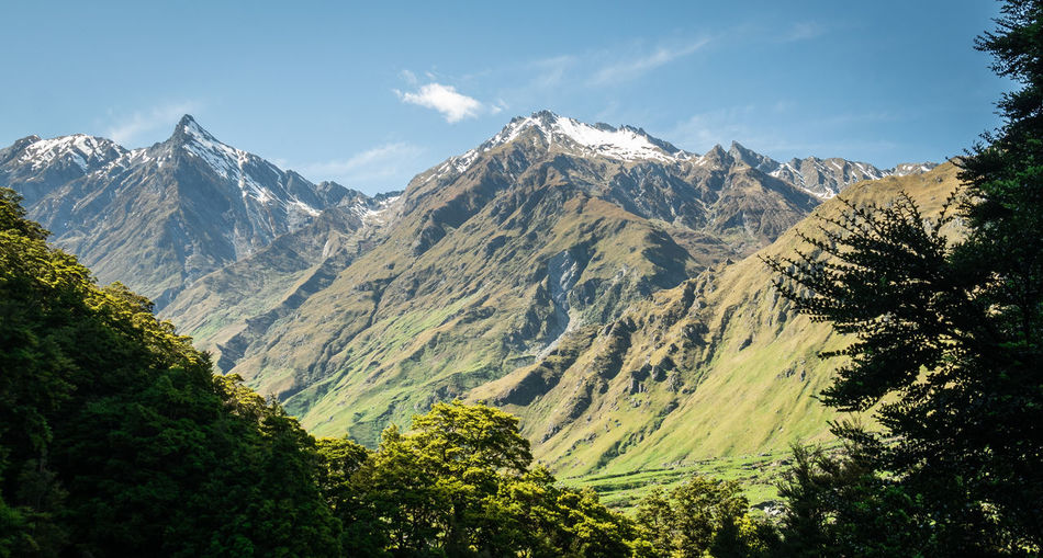 View on usually shaped mountains during sunny day, made on rob roy glacier track in new zealand