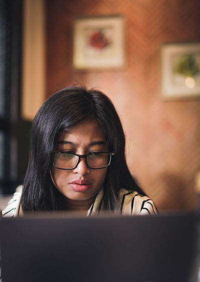 Asian woman working in front of laptop