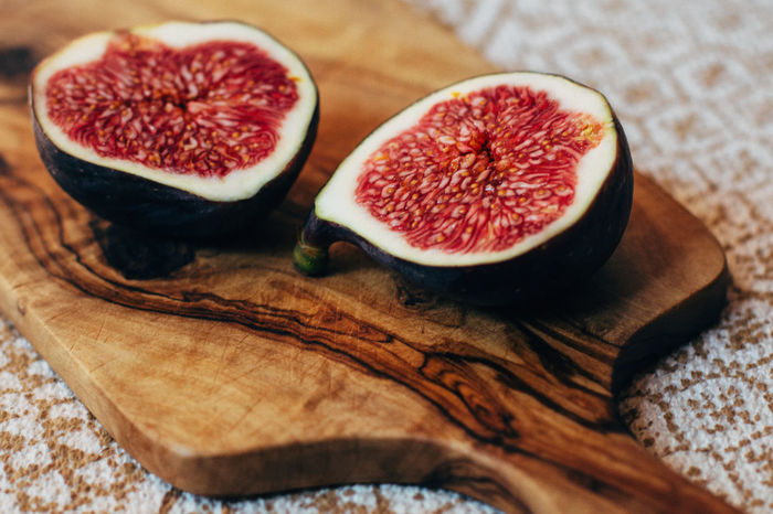 Close-up of cut fig on cutting board