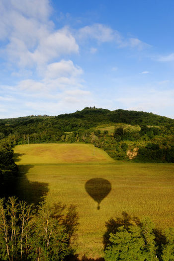 Scenic view of field against sky with balloon shade 