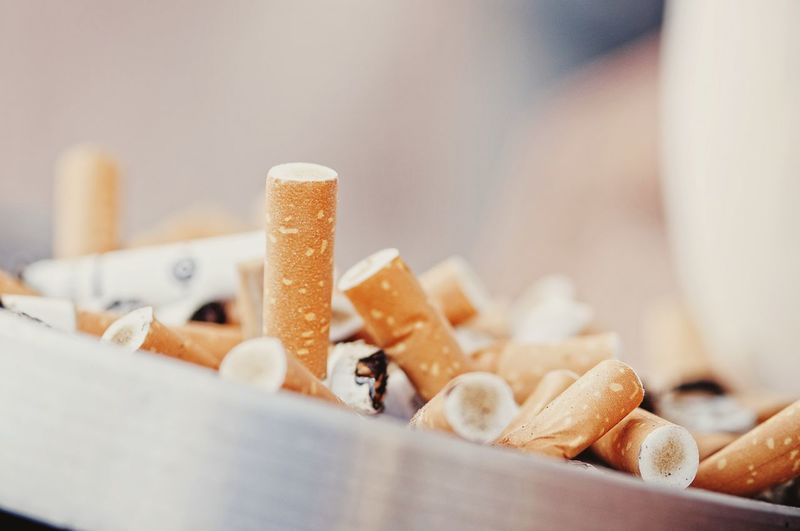 Close-up of cigarette butts in ashtray