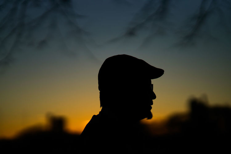 Close-up of silhouette man against sky during sunset