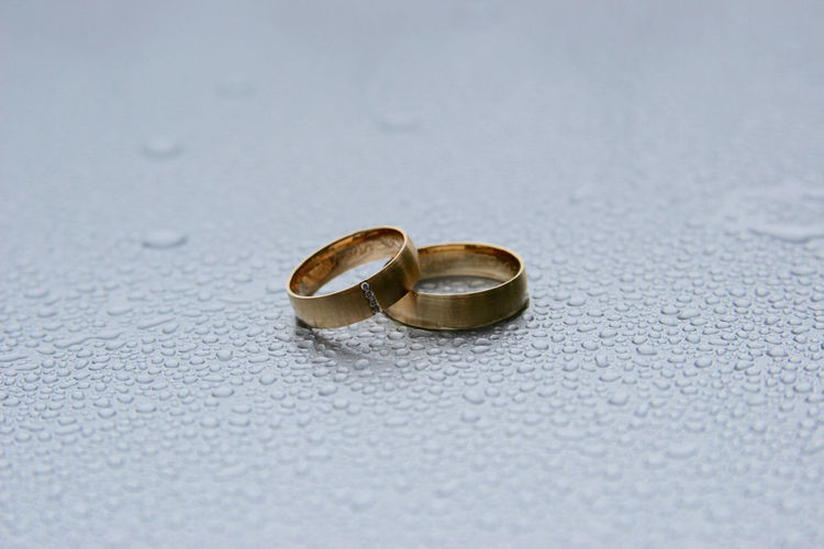 Close-up of wedding rings on floor