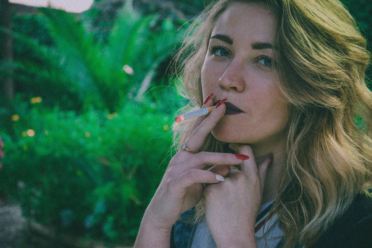 Portrait of woman smoking cigarette