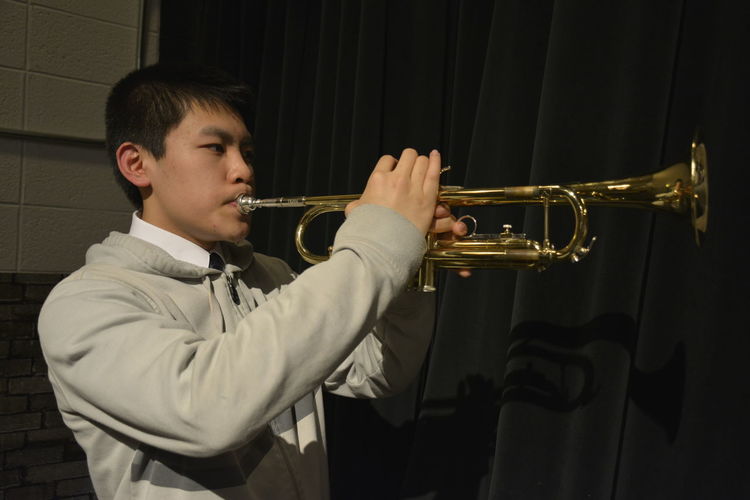 Young man playing trumpet