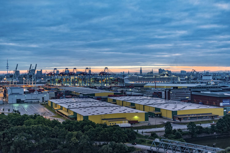 View of clouds over harbor and cityscape