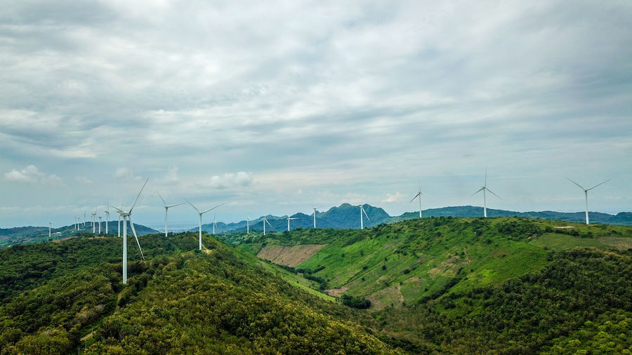 Scenic view of green landscape against sky