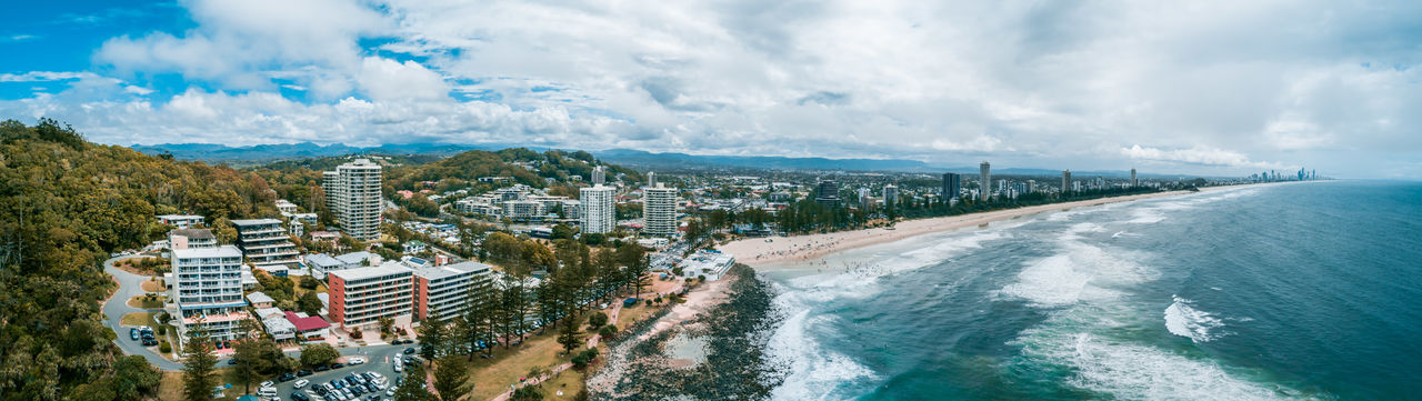 Panoramic view of buildings and sea against sky