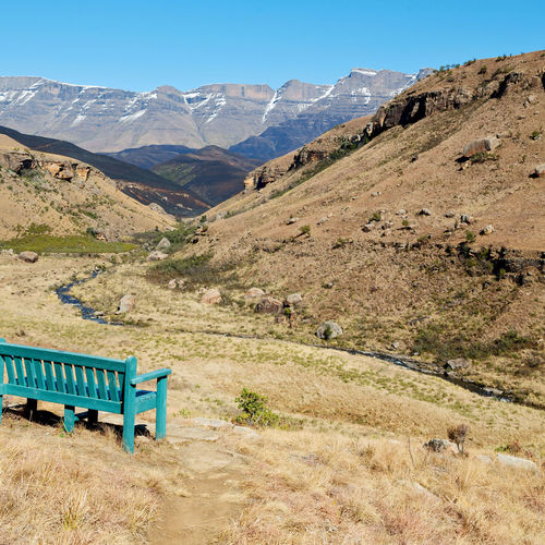 Scenic view of field and mountains against sky
