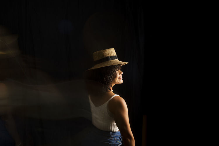 Time-lapse view of woman moving a hat. long exposure, motion blur. happy woman. salvador, brazil.