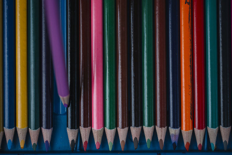 Full frame shot of colored pencils arranged on table