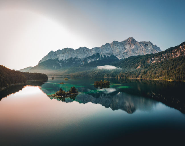 Scenic view of lake and mountains against sky