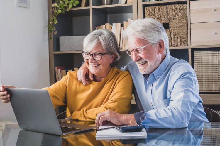 Senior man using laptop while sitting at office
