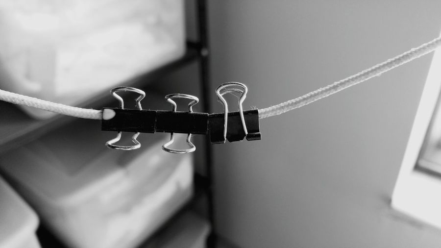 Close-up of binder clip on rope
