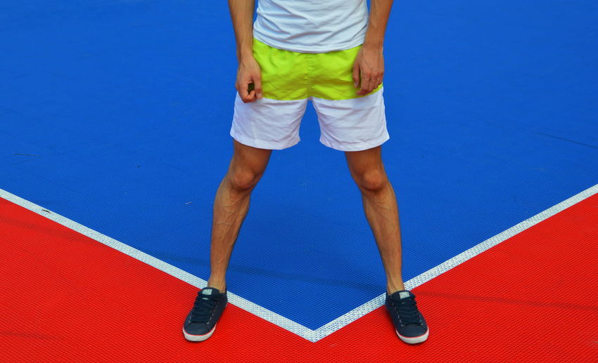 Low section of athlete standing on field