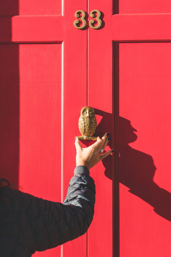 Cropped hand knocking door 