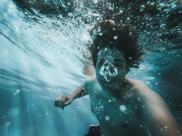 Man swimming underwater in sea