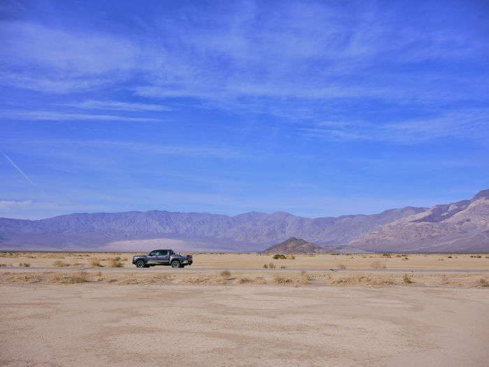 A toyota truck parked on the side of a death valley desert highway