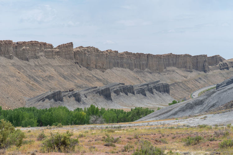 Landscape of barren grey and yellow stone formations near hanksville, utah