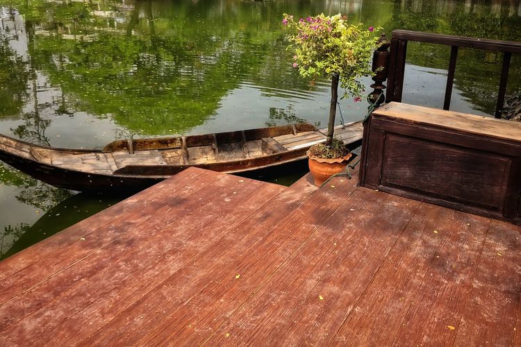 Wooden table by lake