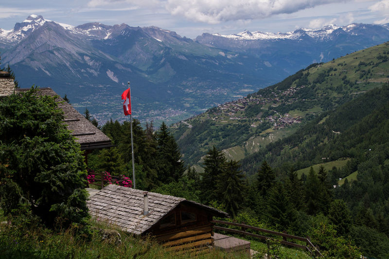 Swiss flag and houses against mountains