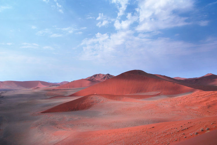 View of desert against cloudy sky