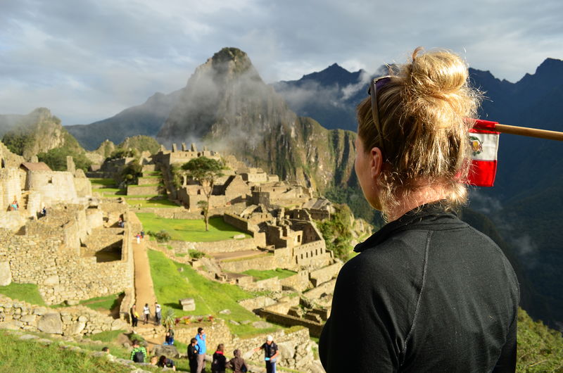 Rear view of young woman looking at machu picchu