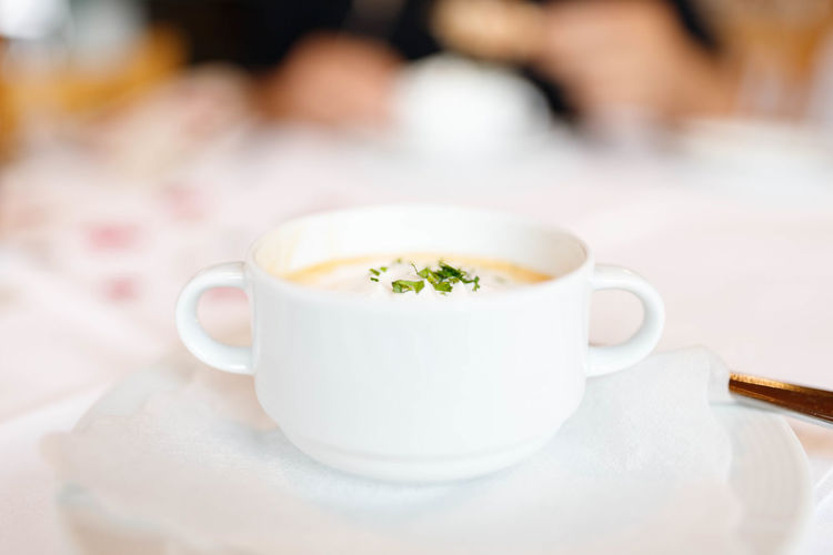 Close-up of soup cup on table