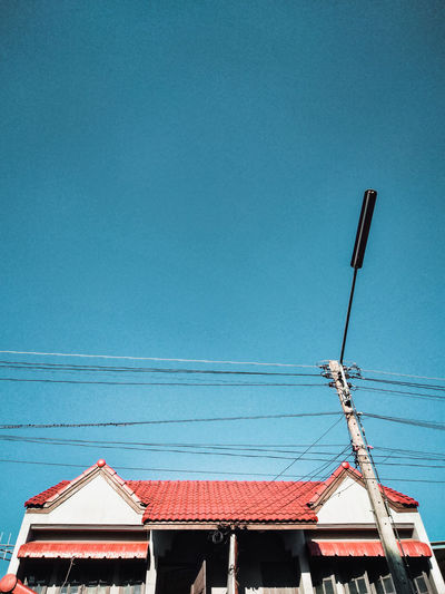 Low angle view of house against blue sky