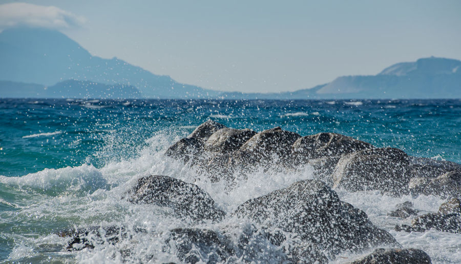 Waves at storm in mediterranean sea beating on breakwater on kos greece