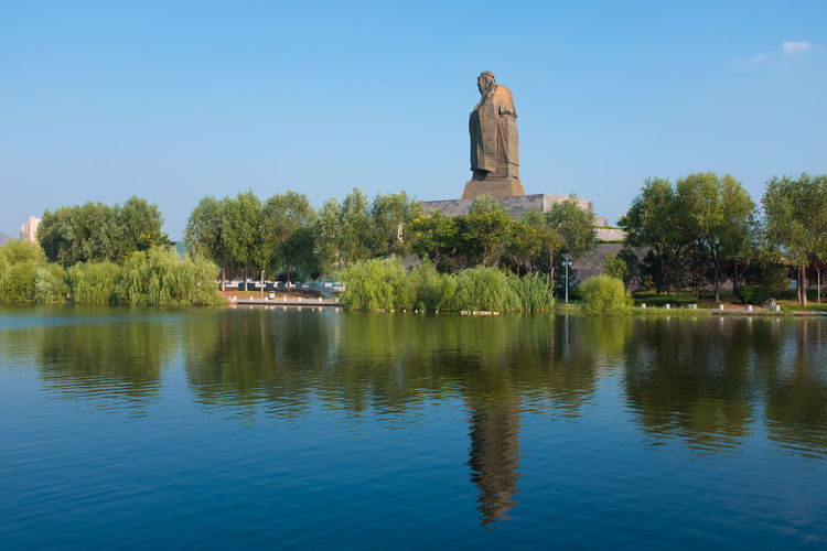 Scenic view of lake against clear blue sky