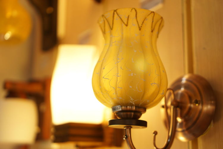 Close-up of illuminated electric lamp at home