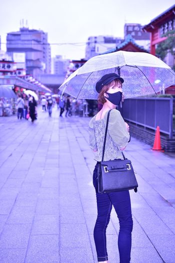 Woman with umbrella walking in rain