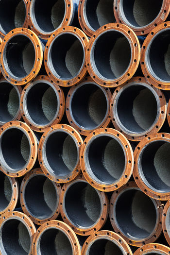 Full frame shot of stack of pipes
